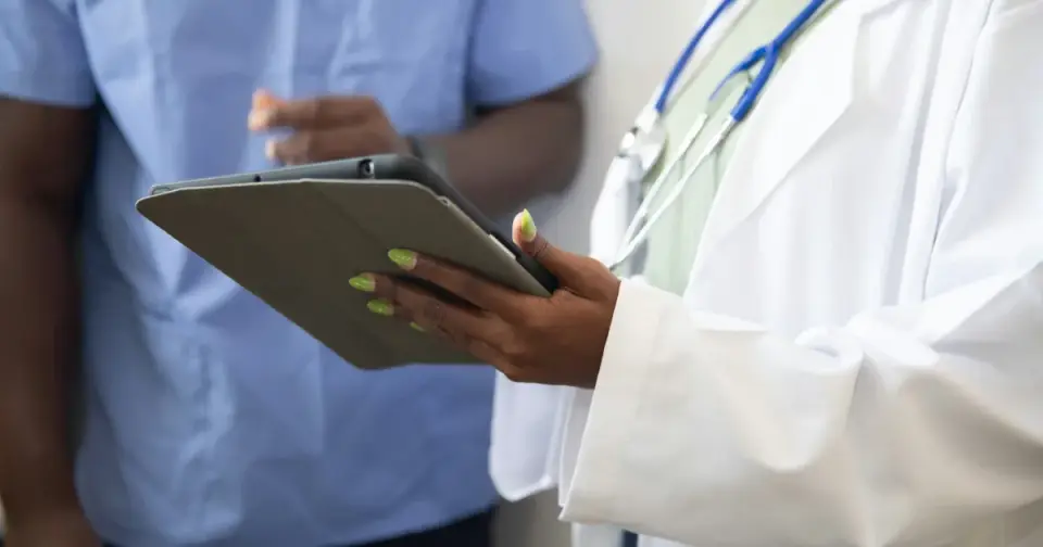 Physician reviewing an individualized NAD+ dosing plan with a patient