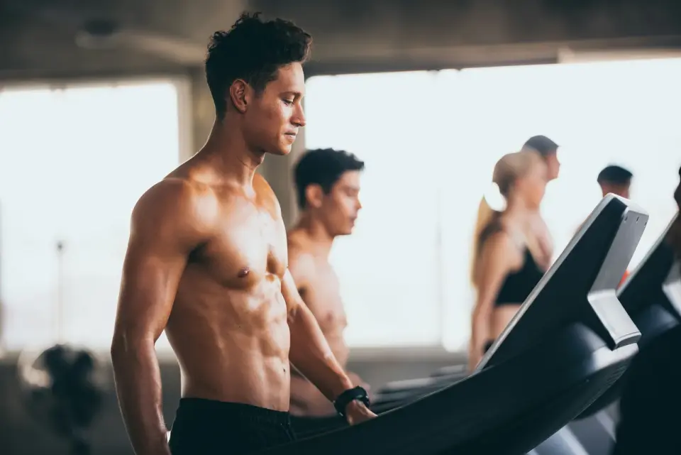 People training on treadmills in a bright gym