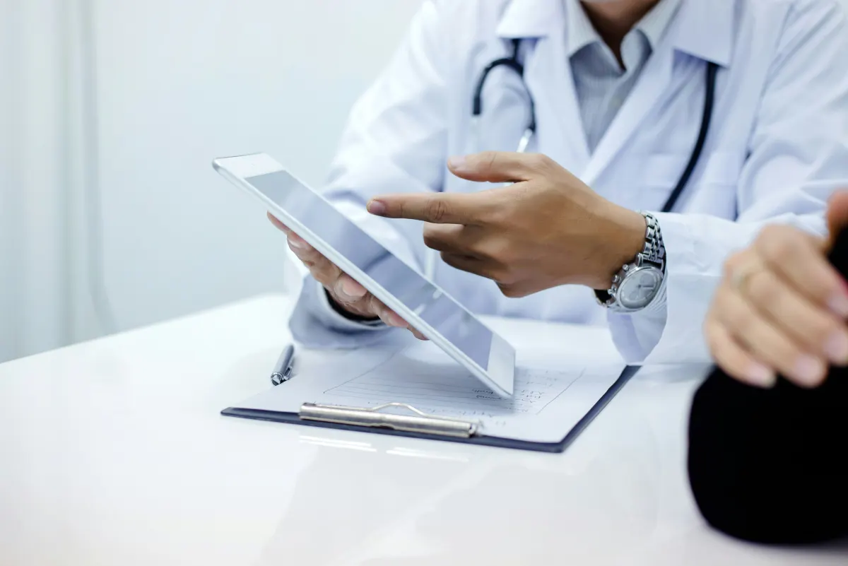 A physician reviewing a patient's lab results on a tablet